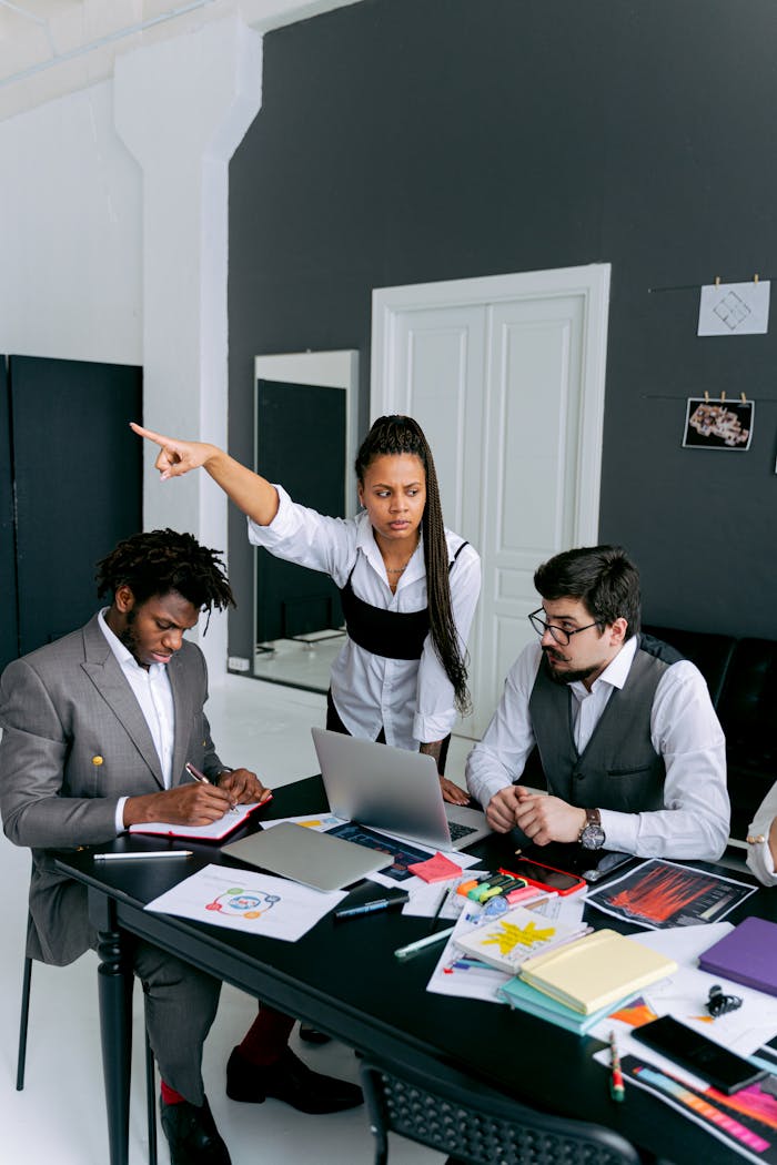 Team members in a heated discussion during a business meeting at a modern office.